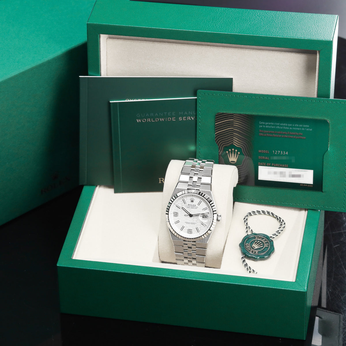 Rolex Land Dweller 2026 Complete 40mm Oystersteel and 18k White Gold Intense White Honeycomb Motif Dial 18k White Gold Fluted Bezel Oystersteel Flat Jubilee Bracelet with Concealed Crownclasp 127334