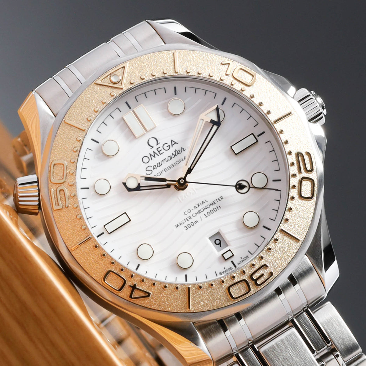 Omega Seamaster Paris 2024 Complete 42mm Stainless Steel and 18k Moonshine Gold White Ceramic Dial 18k Moonshine Gold Unidirectional Bezel Stainless Steel Bracelet 522.21.42.20.04.001