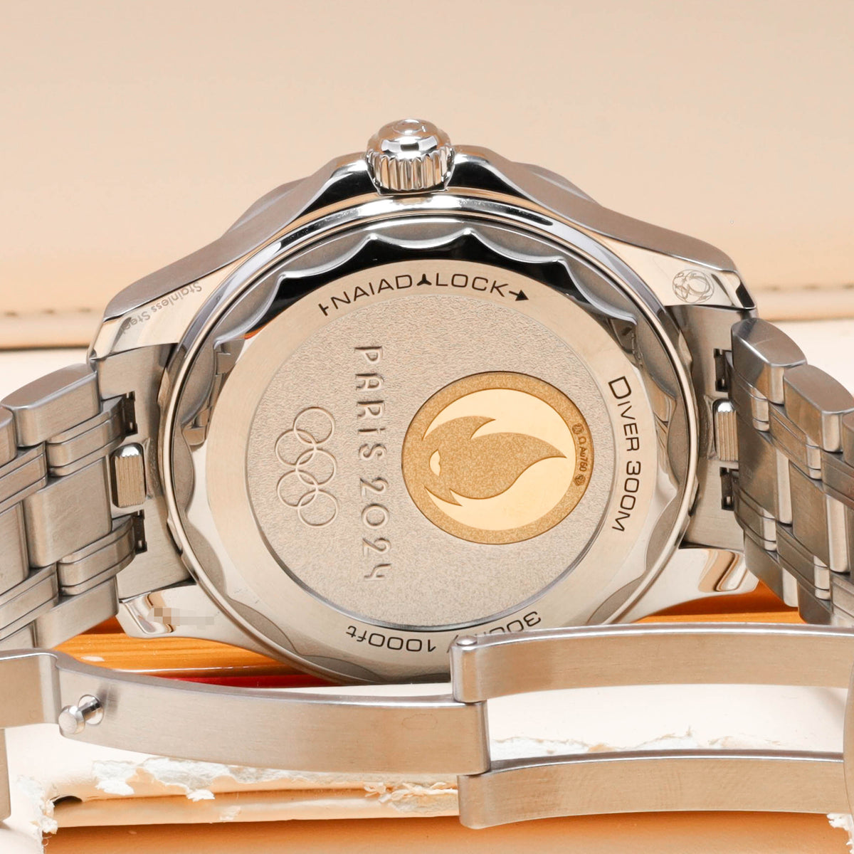 Omega Seamaster Paris 2024 Complete 42mm Stainless Steel and 18k Moonshine Gold White Ceramic Dial 18k Moonshine Gold Unidirectional Bezel Stainless Steel Bracelet 522.21.42.20.04.001