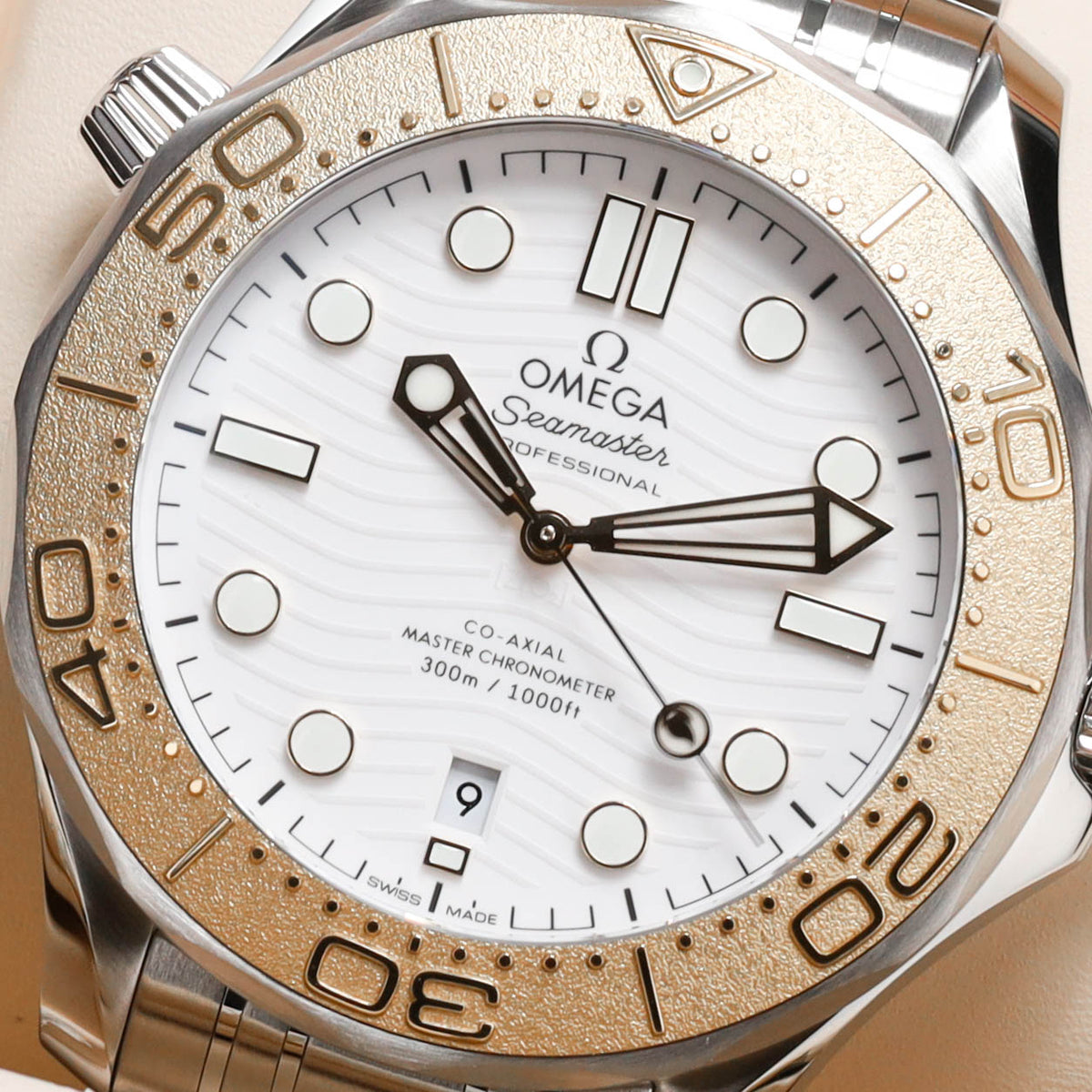 Omega Seamaster Paris 2024 Complete 42mm Stainless Steel and 18k Moonshine Gold White Ceramic Dial 18k Moonshine Gold Unidirectional Bezel Stainless Steel Bracelet 522.21.42.20.04.001