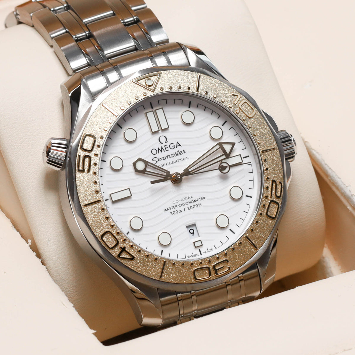 Omega Seamaster Paris 2024 Complete 42mm Stainless Steel and 18k Moonshine Gold White Ceramic Dial 18k Moonshine Gold Unidirectional Bezel Stainless Steel Bracelet 522.21.42.20.04.001