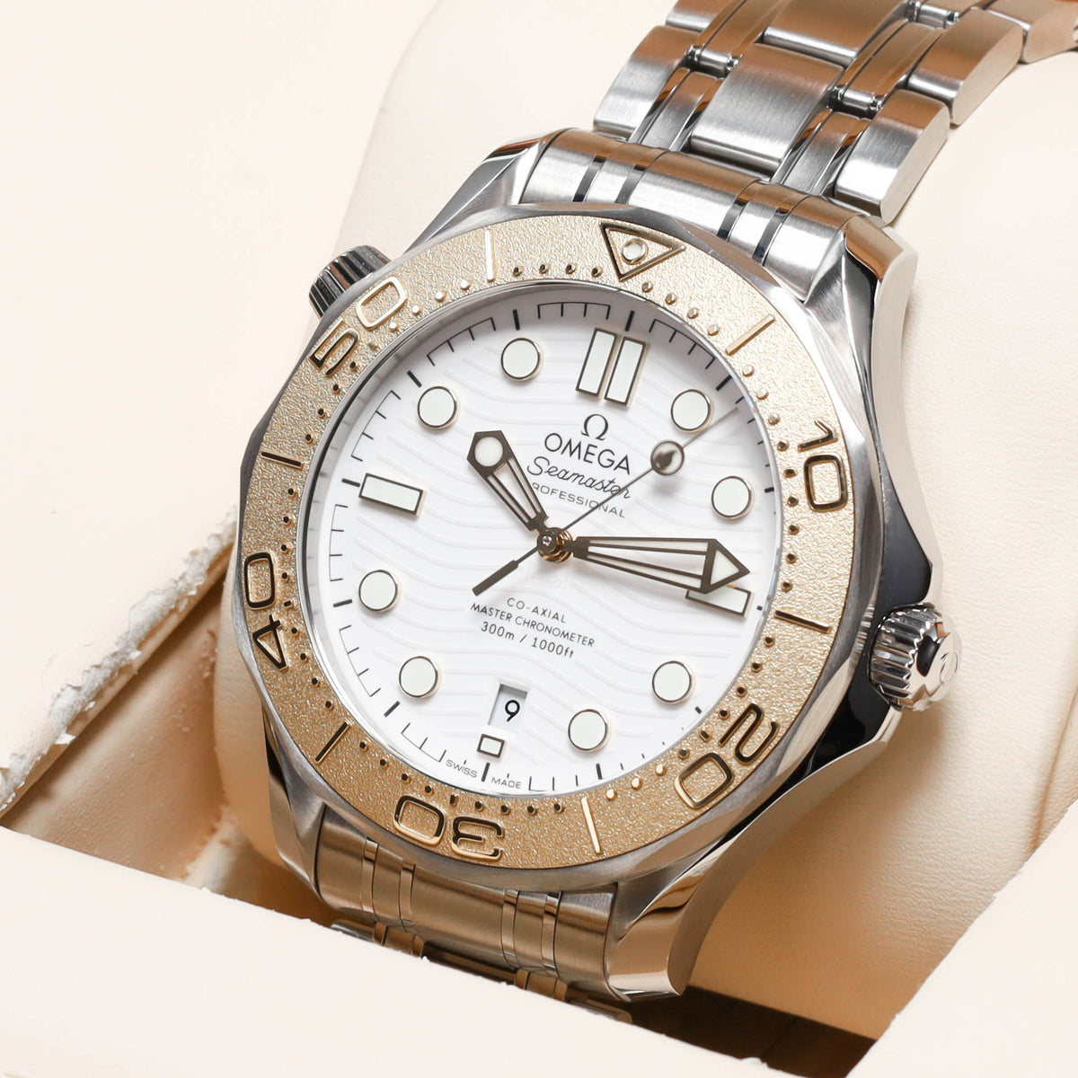 Omega Seamaster Paris 2024 Complete 42mm Stainless Steel and 18k Moonshine Gold White Ceramic Dial 18k Moonshine Gold Unidirectional Bezel Stainless Steel Bracelet 522.21.42.20.04.001