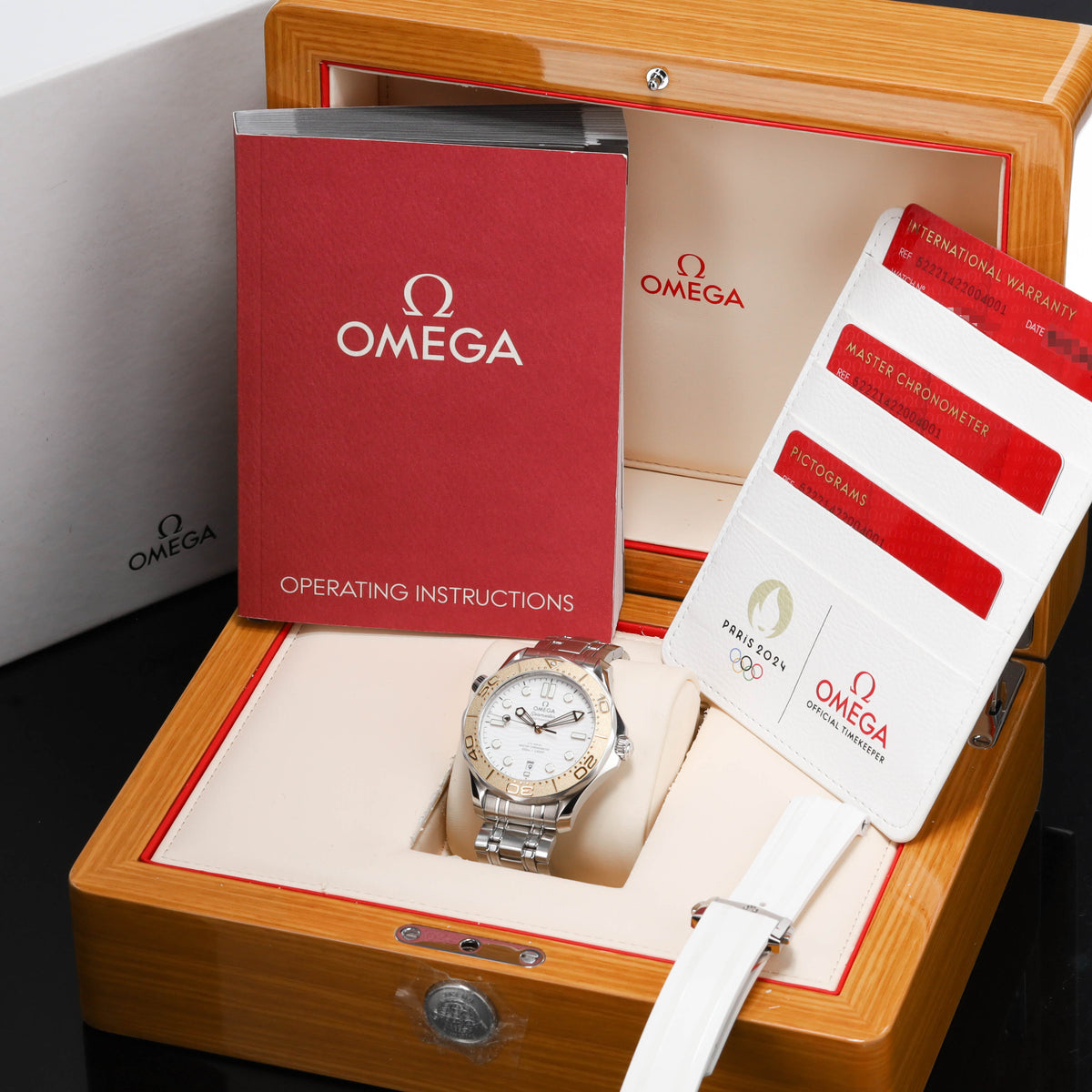 Omega Seamaster Paris 2024 Complete 42mm Stainless Steel and 18k Moonshine Gold White Ceramic Dial 18k Moonshine Gold Unidirectional Bezel Stainless Steel Bracelet 522.21.42.20.04.001